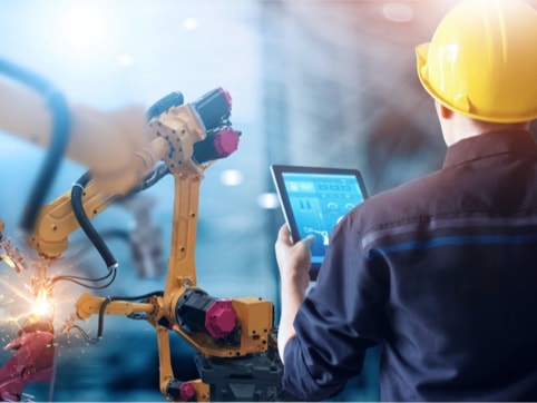 Man with tablet on manufacturing floor